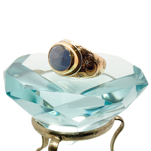 STAR SAPPHIRE AND DIAMONDS SET IN A GALAXY MOTIF YELLOW GOLD RING