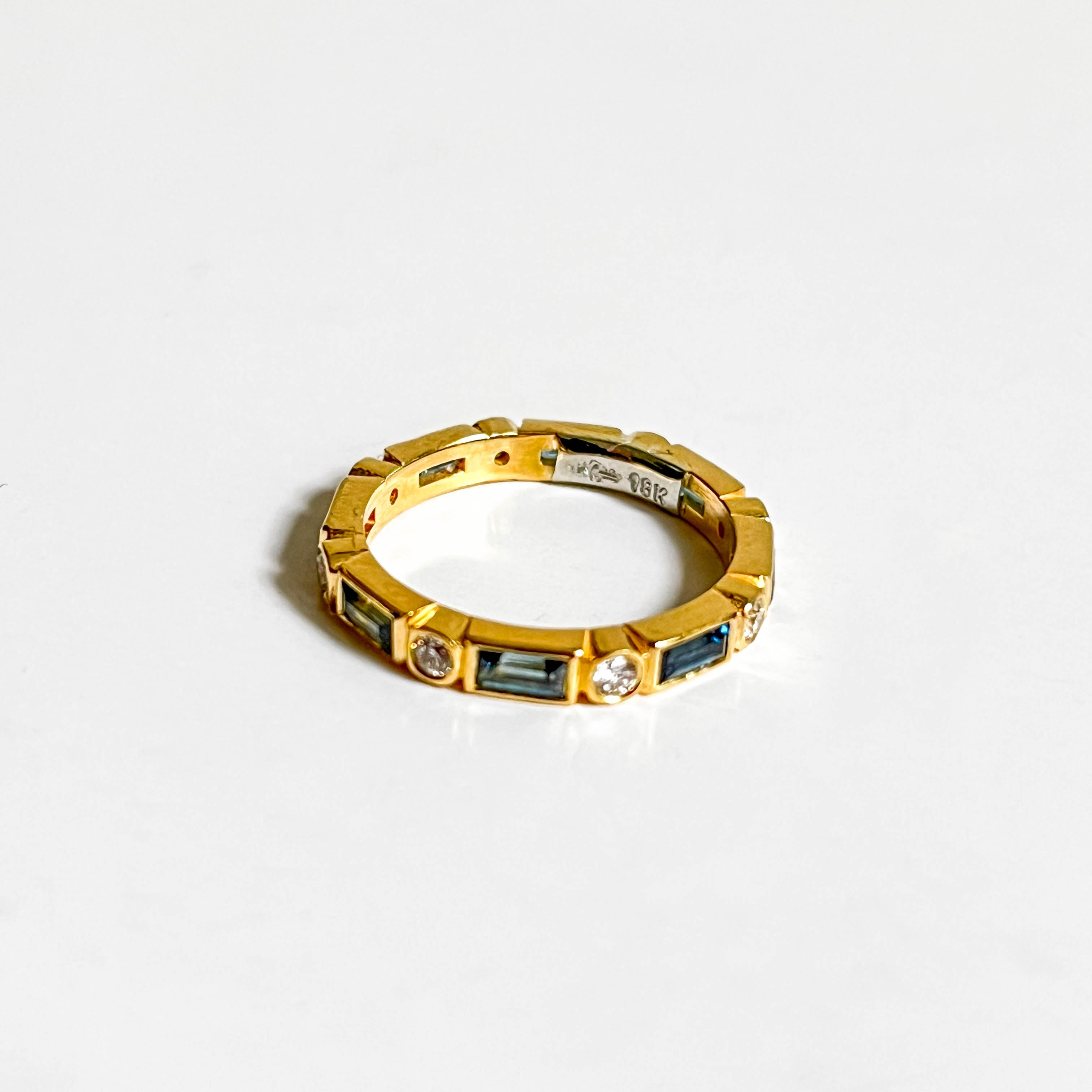 CLEM: Yellow Gold Bezel Set Baguette Teal Sapphires and Round Diamond Eternity Band